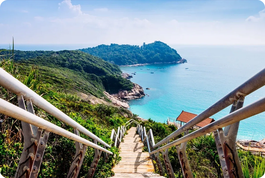 A staircase down to a quiet Mediterranean cove with clear water