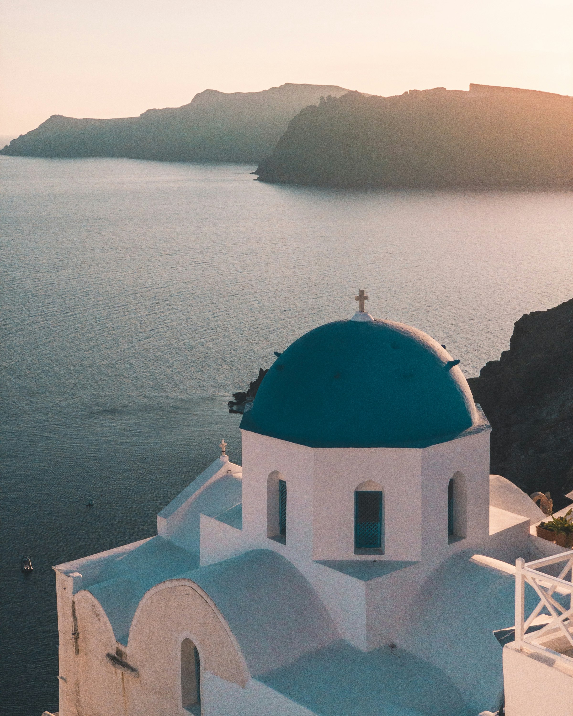 Whitewashed Cycladic village above the Santorini caldera at sunset